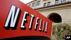 FILE - A sign points to Netfilx headquarters in Los Gatos, California.