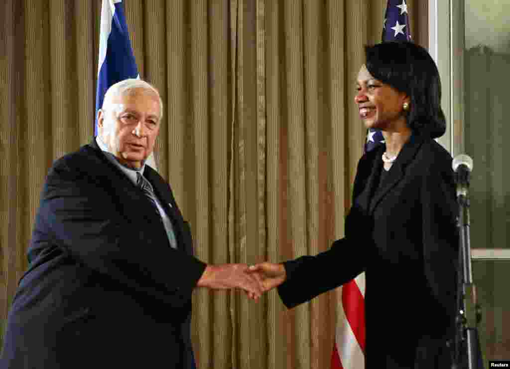 Israeli Prime Minister Ariel Sharon shakes hands with U.S. Secretary of State Condoleezza Rice before their meeting in Jerusalem, Nov. 14, 2005.