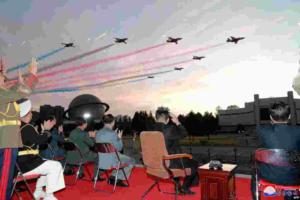 North Korean leader Kim Jong Un, 2nd right, watches a demonstration flight during the opening ceremony of the defense development exhibition "Self-Defence-2021" in Pyongyang, in this picture taken October 11, 2021, and released from North Korea's official Korean Central News Agency on October 12.
