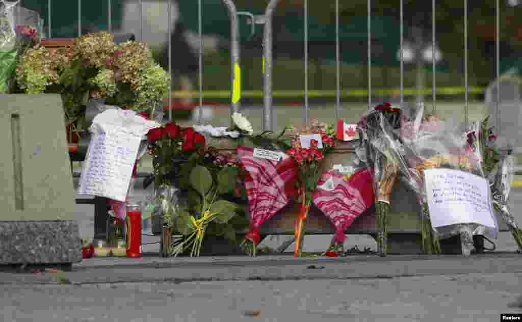 Flowers, momentos and well wishes are placed at the National War Memorial in downtown Ottawa, Oct. 23, 2014.