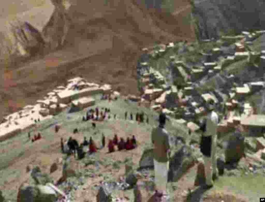 This image made from AP video shows people searching for survivors after a massive landslide landslide buried a village in Badakhshan province, northeastern Afghanistan, May 2, 2014.
