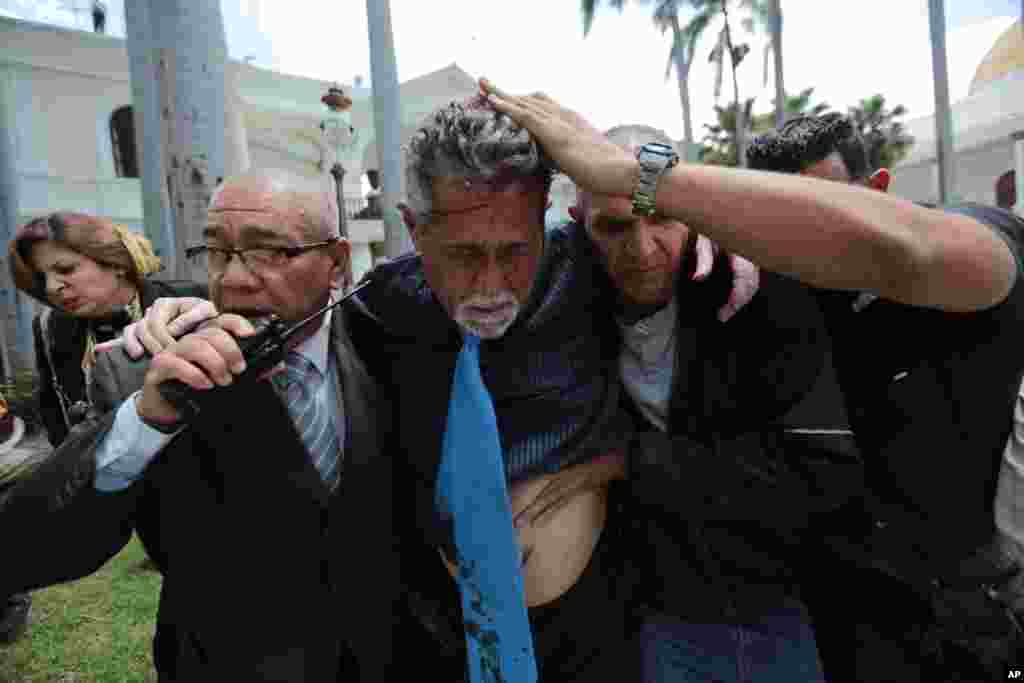 Opposition lawmaker Americo De Grazia is injured when government supporters force their way into the Venezuela's opposition-controlled National Assembly during a special session in Caracas.