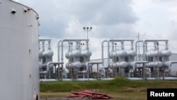 An oil storage tank and crude oil pipeline equipment is seen during a tour by the Department of Energy at the Strategic Petroleum Reserve in Freeport, Texas, U.S., June 9, 2016.