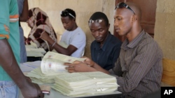 Electoral voter cards are distributed in the capital Bujumbura, Burundi, Thursday, June 4, 2015. 