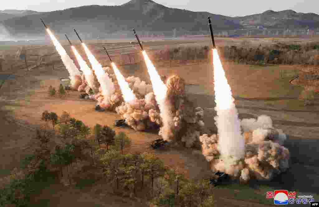 This picture taken on March 18, 2024 and released from North Korea's official Korean Central News Agency (KCNA) shows North Korea's Western Region Artillery Unit's ultra-large rocket salvo firing drill, at an unconfirmed location.