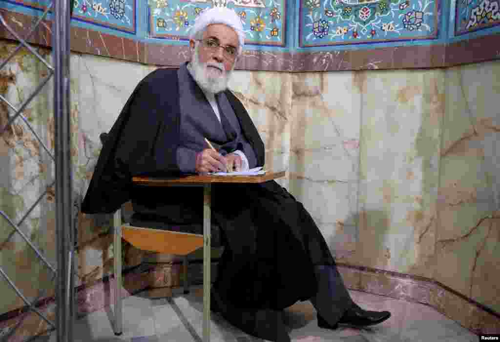 Iran's former Parliament speaker Ali Akbar Nateq-Nouri fills in his ballot during elections for the parliament and Assembly of Experts, in Tehran, Feb. 26, 2016.