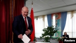 FILE - Belarusian President Alexander Lukashenko casts his vote at a polling station during the parliamentary election in Minsk, Belarus, Nov. 17, 2019. 