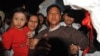 Kyaw Min Yu, center, known as Jimmy, and his wife, Ni Lar Thein, holding her child, in January 2012.