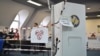 Kosovo electoral commission staff sit at a polling station in the town of Zvecan on April 21, 2024.