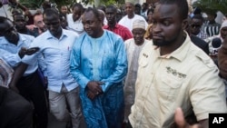 Gambian President-elect Adama Barrow, center, walks after meeting with an Ecowas delegation in Banjul, Gambia, Dec. 13, 2016.