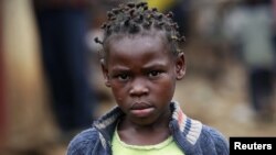 A girl walks along a street in the sprawling Kibera slum, in Nairobi, Kenya, Aug. 26, 2011.