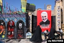 FILE - People visit the grave of senior Iranian military commander General Qassem Soleimani during the one year anniversary of his killing in a U.S. attack, at his hometown of Kerman, Jan. 2, 2021. (Credit: WANA)