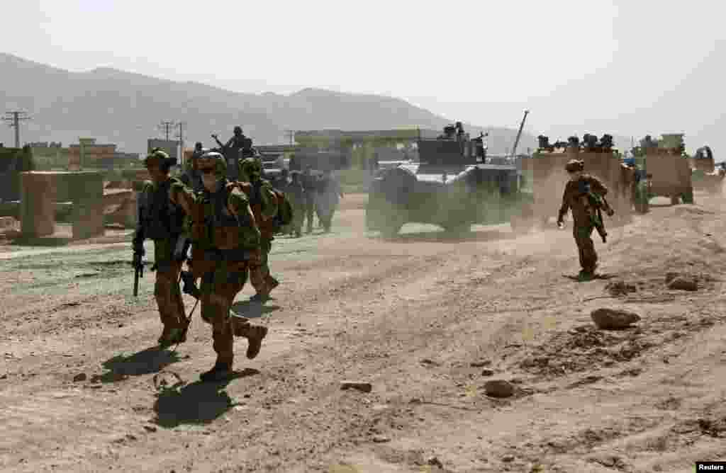 Members of the NATO-led International Security Assistance Force arrive at the site of an attack in Kabul, June 10, 2013.