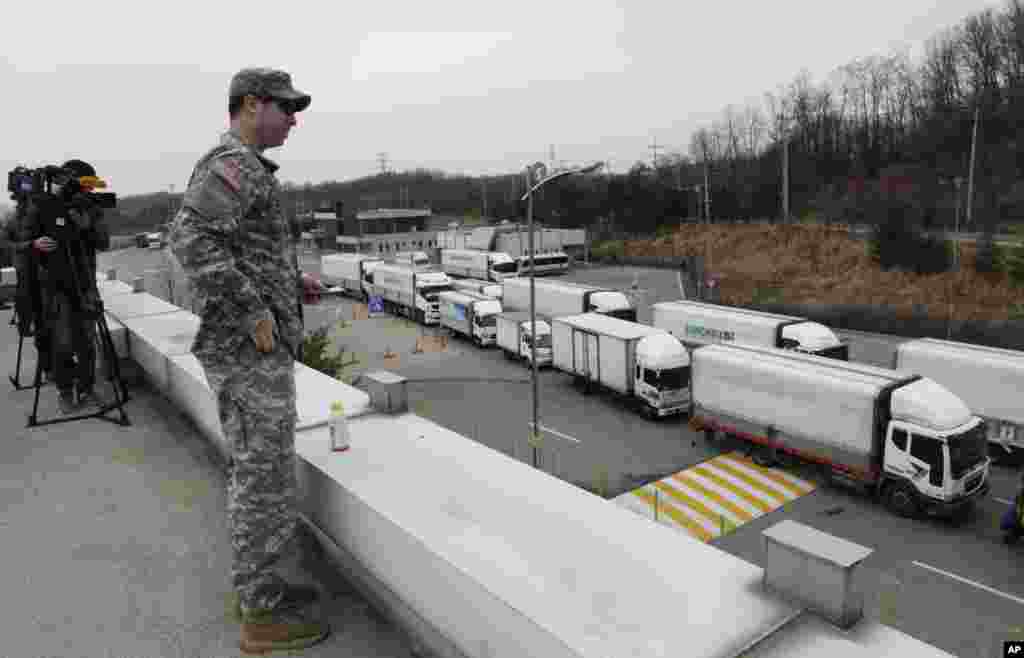 South Korean vehicles return from a joint industrial complex at the North Korean city of Kaesong as a U.S. Army soldier watches at the customs, immigration and quarantine office, near the Demilitarized Zone, March 28, 2013.