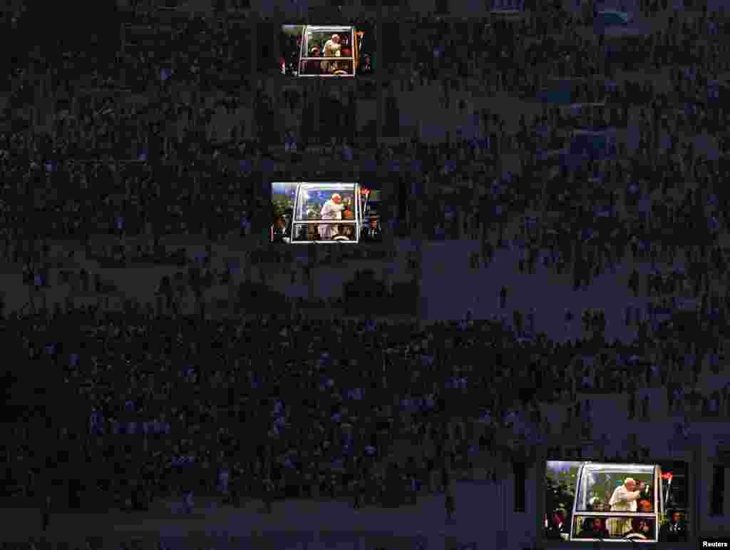 Pope Francis is projected on screens at Copacabana beach in Rio de Janeiro, Brazil, July 26, 2013.
