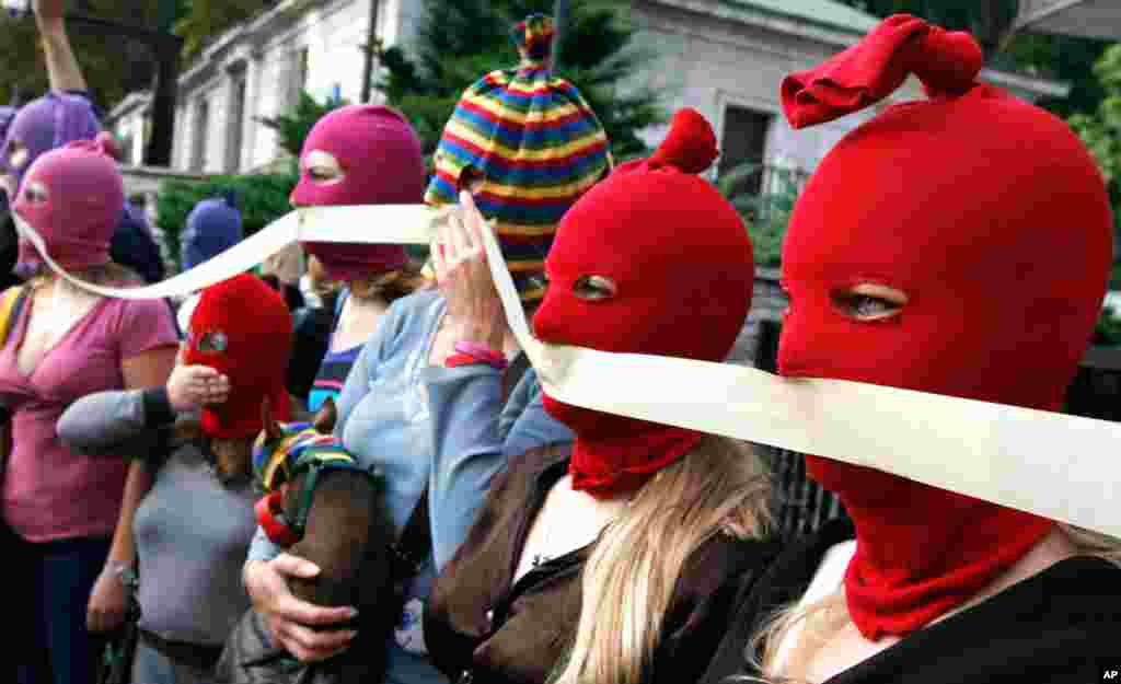 Pussy Riot supporters walk through downtown Warsaw to leave a petition at the Russian Embassy to demand their release.