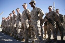 FILE - U.S. Marines watch during a change of command ceremony at Task Force Southwest military field, Helmand province, Afghanistan, Jan. 15, 2018. The final phase of ending U.S. military involvement in Afghanistan began May 1, 2021.