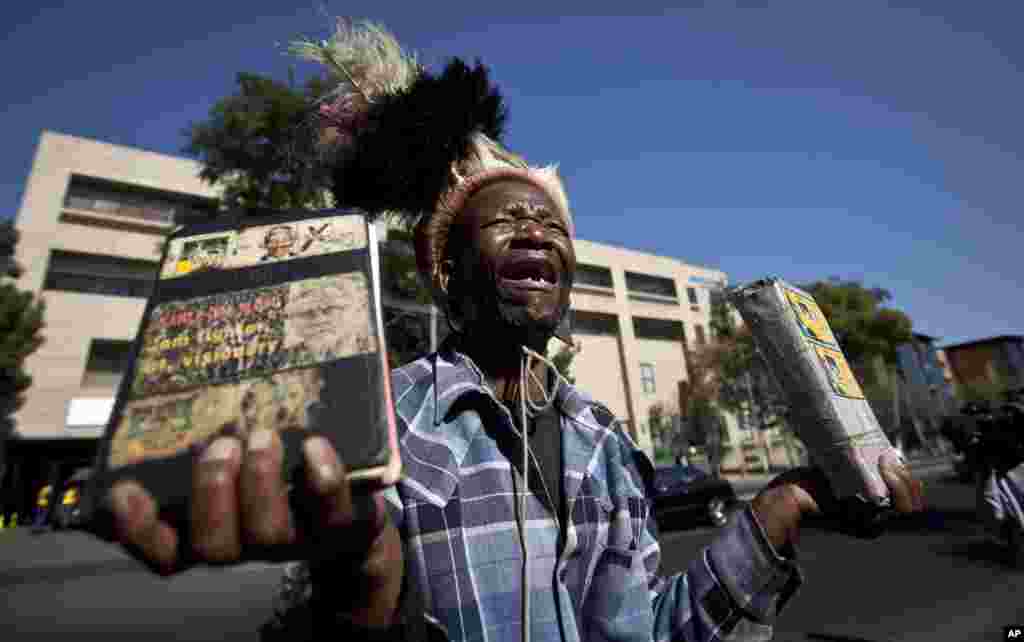 Wellwisher Daniel Sello cries out his thanks to former South African President Nelson Mandela in front of the Mediclinic Heart Hospital in Pretoria, where he is being treated.