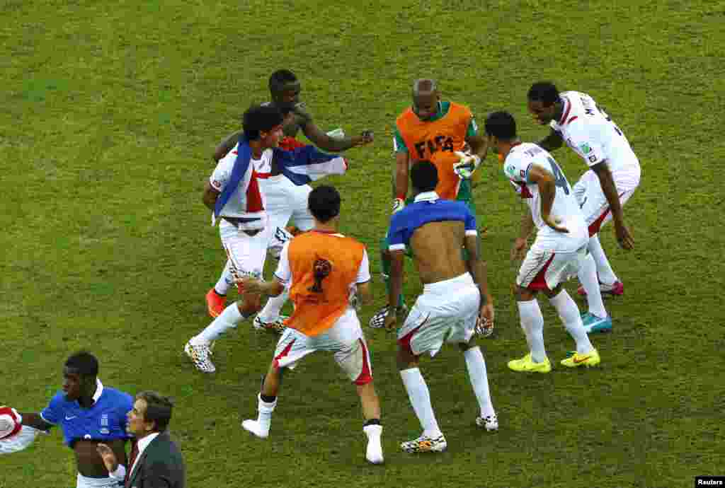Costa Rica's Michael Umana celebrates with teammates after scoring a goal during a penalty shootout against Greece in their 2014 World Cup round of 16 game at the Pernambuco arena in Recife, Brazil, June 29, 2014.