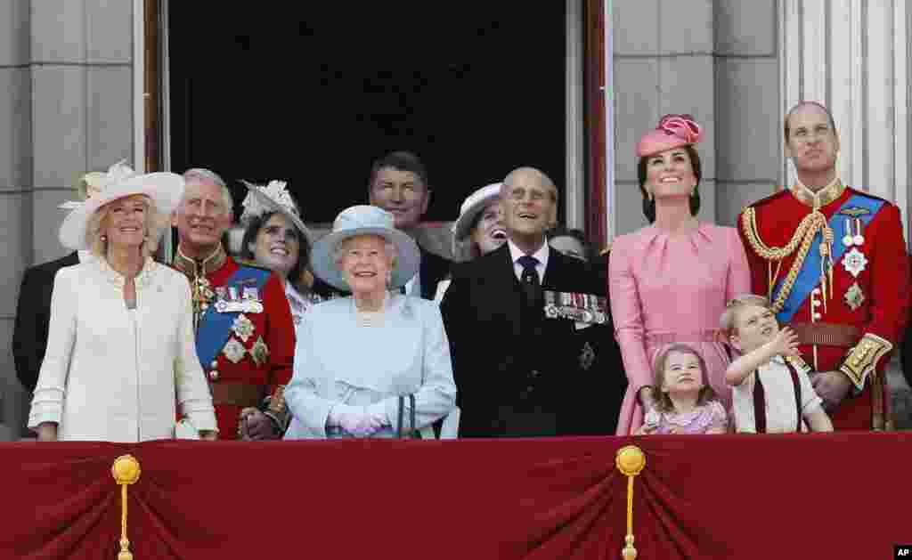 Members of Britain's Royal family from left, Camilla, the Duchess of Cornwall, Prince Charles, Princess Eugenie, Queen Elizabeth II, background Timothy Laurence, Princess Beatrice, Prince Philip, Kate, the Duchess of Cambridge, Princess Charlotte, Prince George and Prince William watch a fly past as they appear on the balcony of Buckingham Palace, after attending the annual Trooping the Colour Ceremony in London, June 17, 2017.