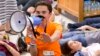 Marjorie Stoneman Douglas High School student David Hogg speaks as demonstrators lie on the floor at a Publix Supermarket in Coral Springs, Fla., May 25, 2018.