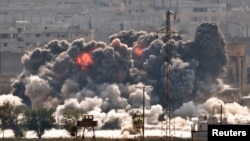 Smoke and flames rise from an Islamic State fighters' position in the town of Kobani during airstrikes by the US led coalition. (AP Photo/Vadim Ghirda)