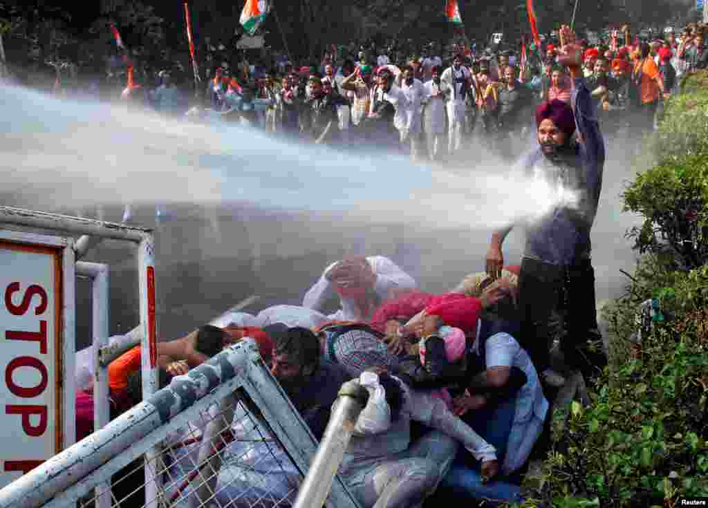 A demonstrator is hit by a water cannon used by police during a protest against what they say is state government’s failure to arrest those involved in the sacrilege of Guru Granth Sahib, the religious book of Sikhs, in Behbal Kalan village of Punjab in 2015, in Chandigarh, India, Oct. 26, 2016.