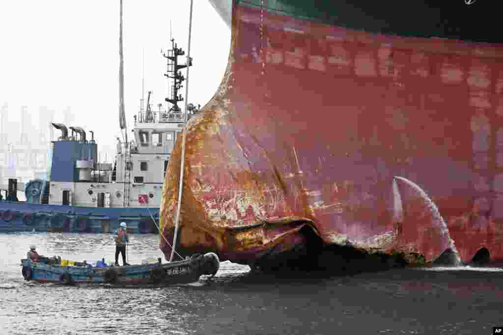 This photo released by Xinhua News Agency shows a view of the damaged part of the Ever Given container ship berthed at a ship-repairing dock of Qingdao Beihai Shipbuilding Heavy Industry Co., Ltd. in Qingdao in eastern China's Shandong Province, Oct. 4, 2021.