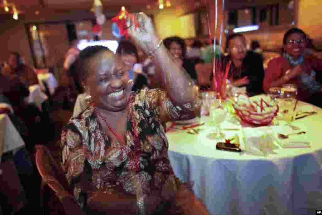 Harriet Garrett reacts while watching the first Presidential debate between Republican presidential candidate, former Massachusetts Gov. Mitt Romney, and President Barack Obama at a restaurant in the West Oak Lane section of Philadelphia.