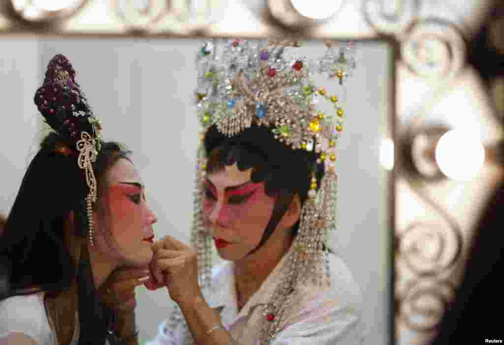 Performers get ready for a Chinese opera performance for elderly guests ahead of Lunar New Year in Singapore. The show was organized by Shan You, a voluntary welfare organization, which was raising funds to continue their services for the elderly.