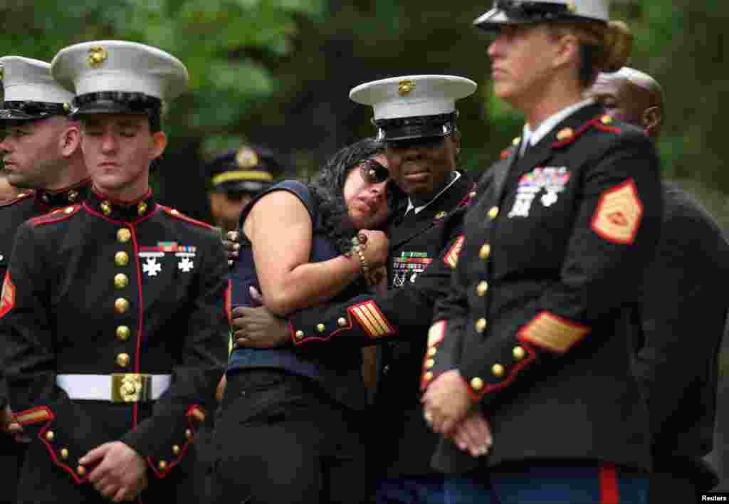 Fellow Marines pay their respects to Marine Corps Sgt. Johanny Rosario Pichardo, who was among 13 U.S. service members killed in the airport suicide bombing in Afghanistan's capital Kabul, in her hometown in Lawrence, Massachusetts, Sept. 14, 2021.