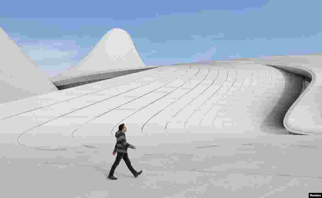 A man walks outside the Heydar Aliyev Center in Baku, Azerbaijan.