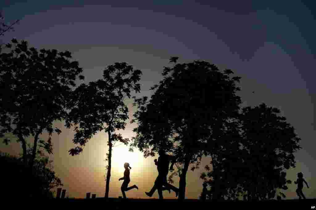 An Egyptian family spends time at Al-Azhar Park, one of the bustling city's few public parks as the sun sets in Cairo, Egypt.