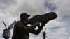 A Ukrainian serviceman tests an anti-drone gun during a presentation of radio-electronic warfare and radio-electronic intelligence systems of the Ukrainian company Kvertus in Lviv region on May 28, 2024.