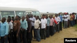 FILE - Former Nigerian militants queue to register at an arms collection center in Ogoloma-Okrika district, around 50 km (30 miles) east of the oil hub Port Harcourt. 