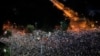 People flash the lights of their mobile phones during an anti-government protest in Victoria Square, outside the government headquarters in Bucharest, Romania, Aug. 10, 2019. 