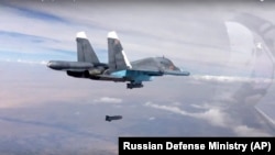 A bomb is released from Russian Su-34 strike fighter in Syria, Oct. 9, 2015.