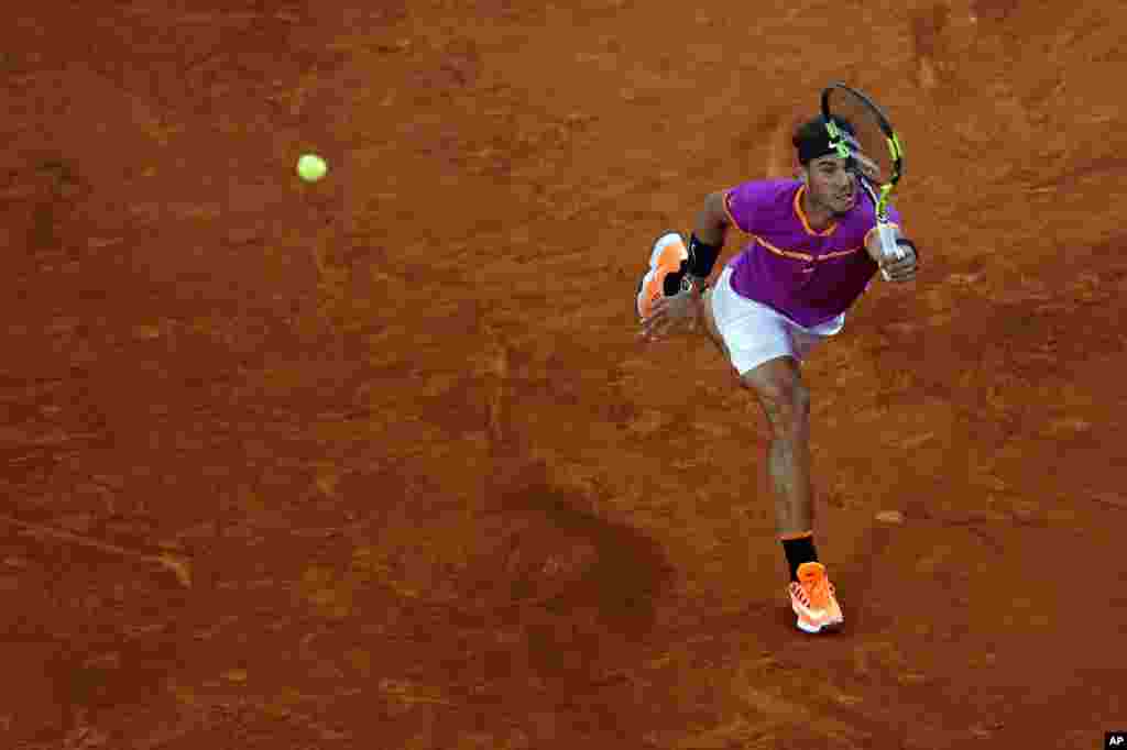 Rafael Nadal from Spain returns a ball to David Goffin from Belgium during a Madrid Open tennis tournament match in Madrid, Spain.