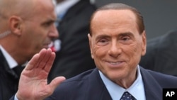FILE - Opposition leader Silvio Berlusconi of Italy arrives for a meeting of the European People's Party prior to an EU summit in Brussels on Thursday, Oct. 19, 2017. 