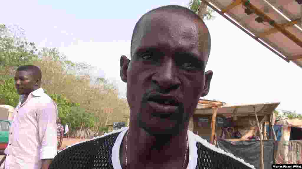 Musa Haruna, 32, has been living at the New Kuchogoro camp since 2014. He told VOA he is worried about the health of his child now that his money has run out. (N. Pinault /VOA)