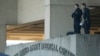 FILE - Security personnel man an observation post on the roof to the entrance of the Walter Reed Army Medical Center in Bethesda, Maryland.