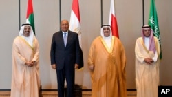 In this July 30, 2017, photo released by Bahrain News Agency, from left to right, Foreign Ministers Abdullah bin Zayed al-Nahyan of the UAE, Sameh Shoukry of Egypt, Khalid bin Ahmed al-Khalifa of Bahrain and Adel al-Jubeir of Saudi Arabia pose for a photo during their meeting in Manama, Bahrain. The four Arab states that cut ties with Qatar met Sunday to discuss the diplomatic crisis.