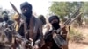 Members of a "bandit" gang pose with weapons at their forest hideout in northwestern Zamfara state, Nigeria, Feb. 22, 2021. 