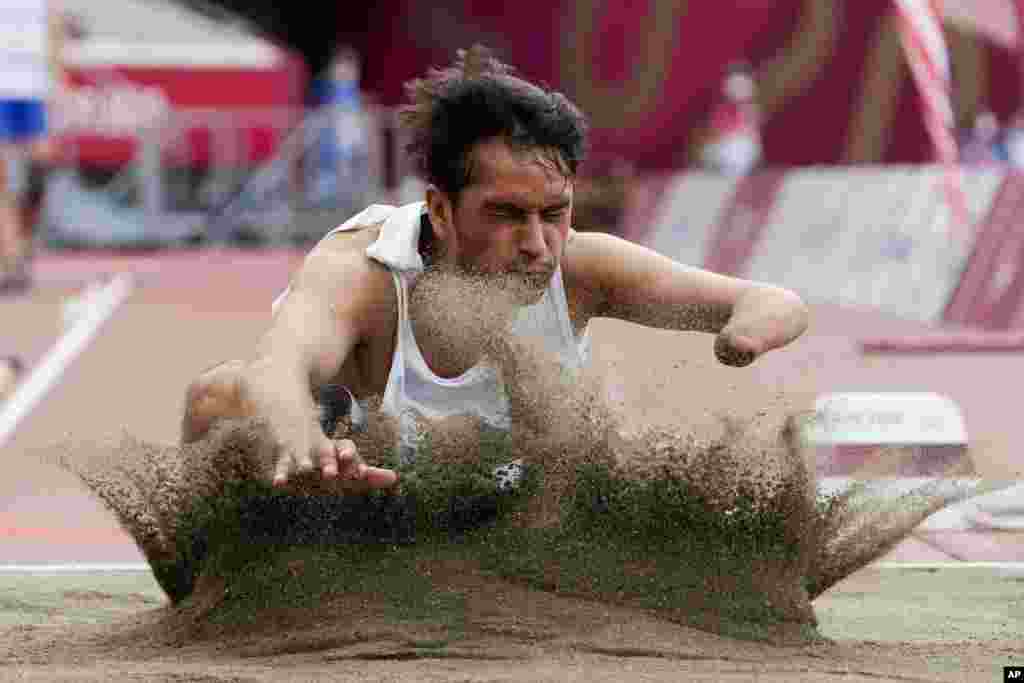 Afghanistan's Hossain Rasouli competes in the men's T47 long jump during the 2020 Paralympics at the National Stadium in Tokyo, Japan.