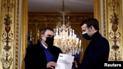 French President Emmanuel Macron meets historian Benjamin Stora for the delivery of the report on the memory of the colonization and the Algerian war at the Elysee Palace in Paris, France, Jan. 20, 2021.