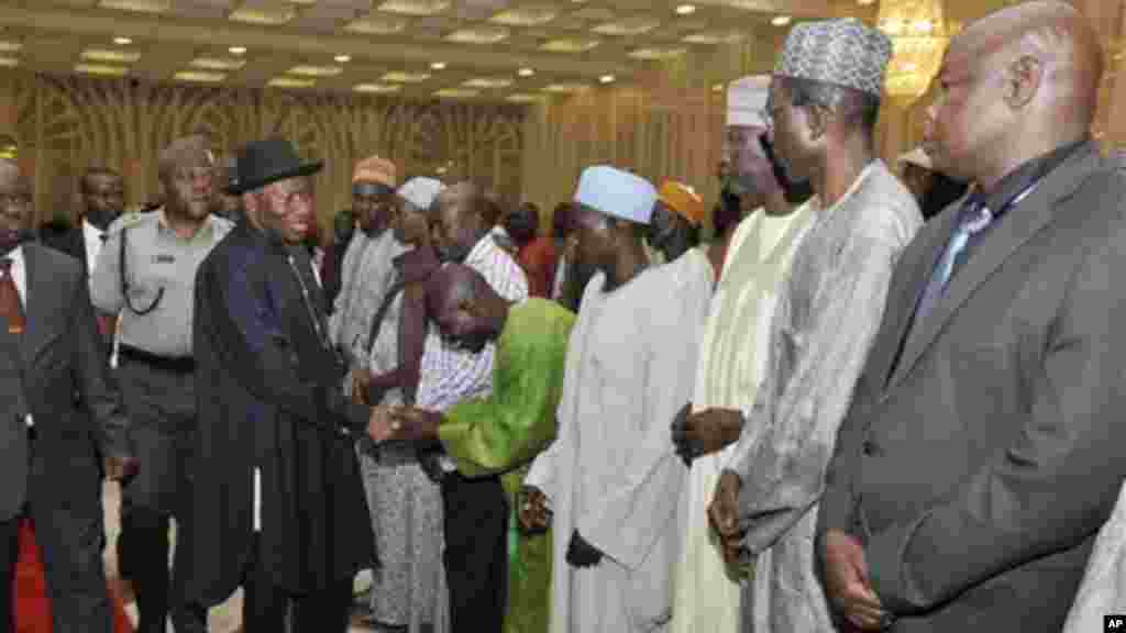 Goodluck Jonathan, then-president of Nigeria, greets parents of girls kidnapped in Chibok, in Abuja, July 22, 2014.