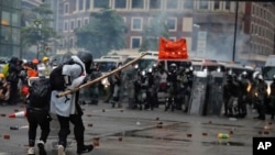 Protesters use bamboo sticks as they face riot police during a protest in Hong Kong, Sunday, Aug. 25, 2019.