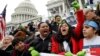 Protesters urge Congress to pass a bill that will allow undocumented immigrants who were brought to America as children to permanently stay in the country, on the Senate steps in Washington, Dec. 6, 2017.
