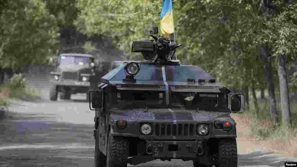 Ukrainian servicemen ride in an armored vehicle in Kramatorsk, Sept. 1, 2014.