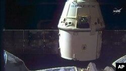 In this frame grab taken from NASA Television, a SpaceX Dragon capsule separates from a robotic arm of the International Space Station en route back to Earth with a load of science experiments and gear from the space station, Aug. 26, 2016. 